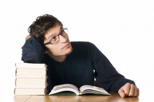 Young man studying on books